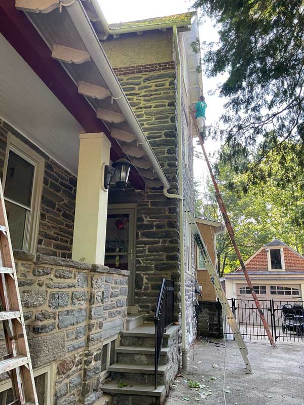 Exterior Painters working outside painting the house